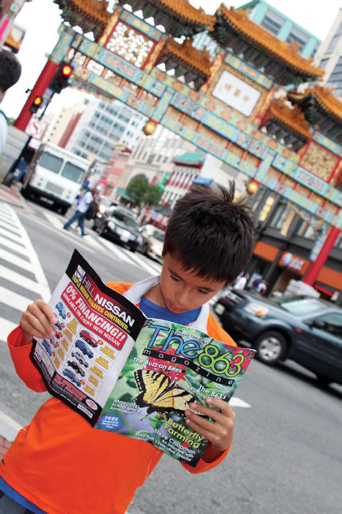 Elijah Bauer reads the May 2014 issue while visiting Chinatown in Washington D.C.; submitted by Thanh Bauer. We love the composition and colors!